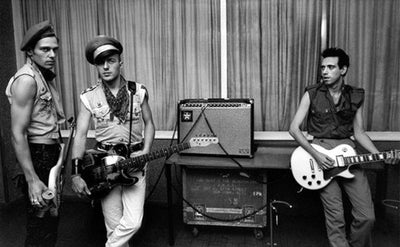 The Clash, Paul Simonon, Joe Strummer, Mick Jones, ‘Backstage, Manchester Apollo, No.II’ © Adrian Boot at Proud Galleries